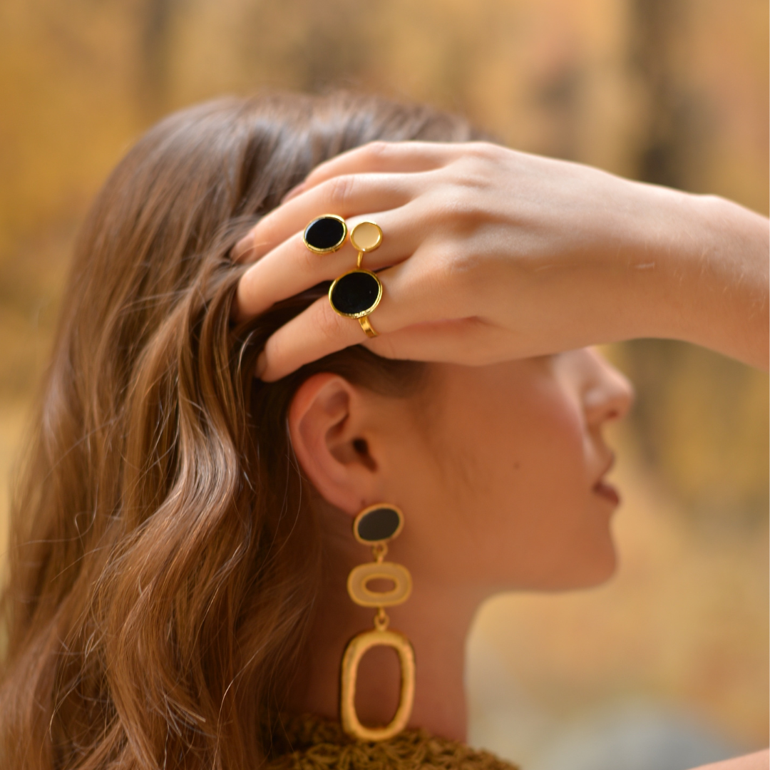 The Duo Roma Ring handmade by Colombian artisans in bronze with 24-karat gold plating an enamel finish