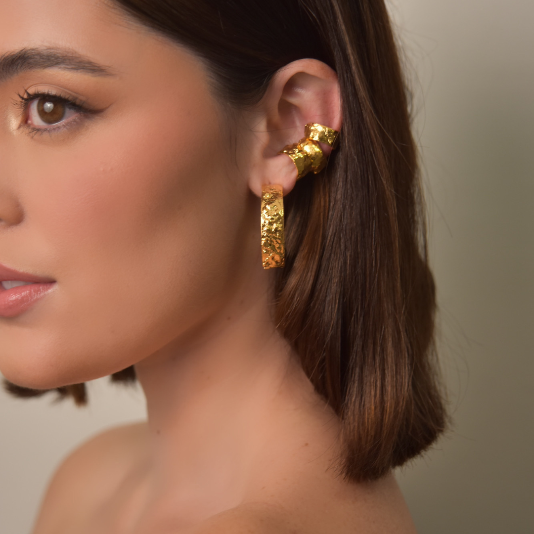 The Kokina Maxi Hoop earrings are handmade by Colombian artisans in bronze with 24-karat gold plating.