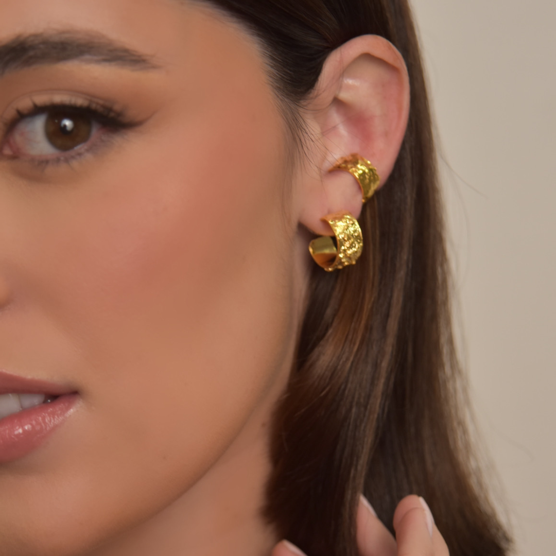 The Kokina Mini Hoop earrings are handmade by Colombian artisans in bronze with 24-karat gold plating.