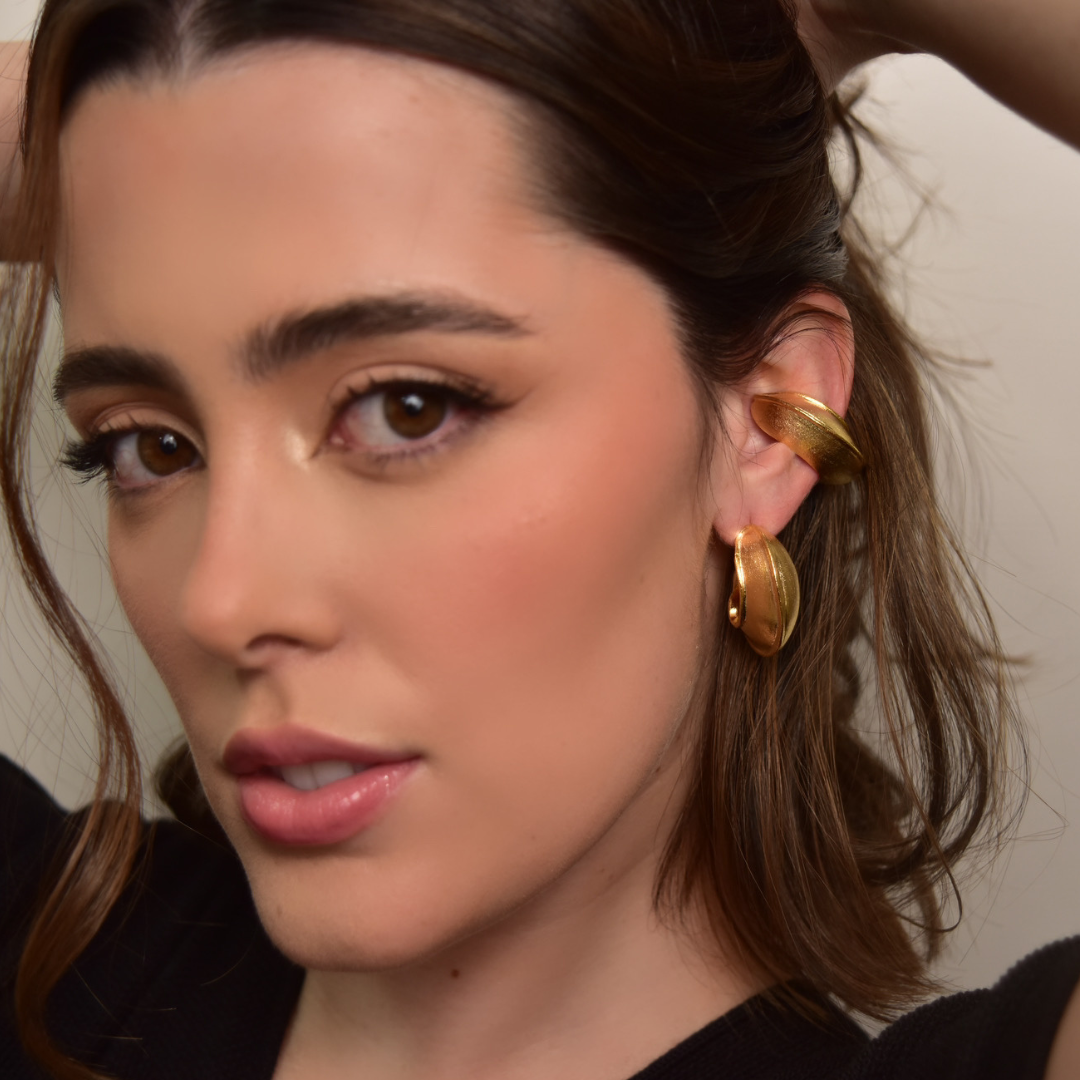 The Nutty Hoop earrings are handmade by Colombian artisans in bronze with 24-karat gold plating.