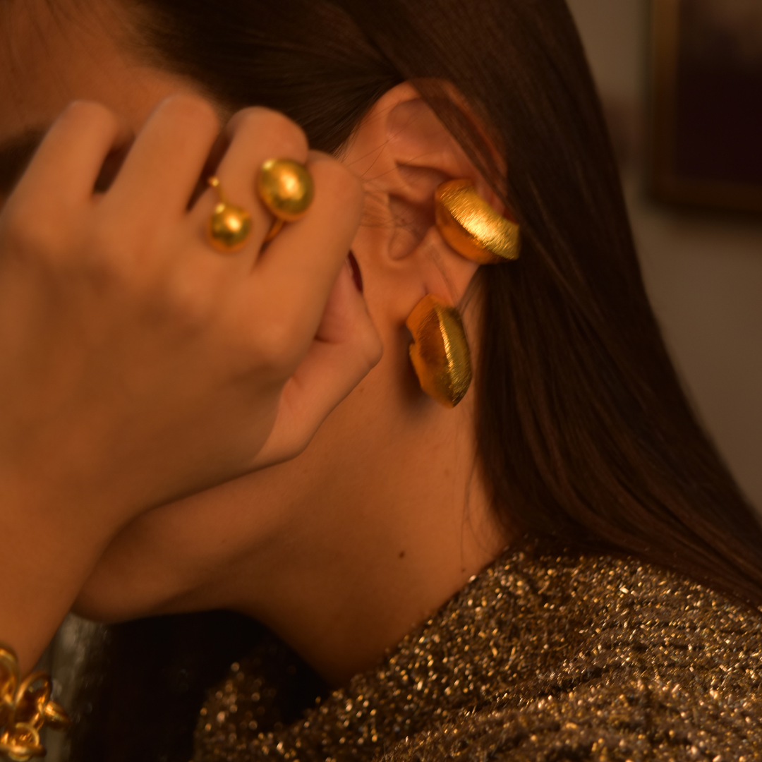 The Pima Hoop earrings are handmade by Colombian artisans in bronze with 24-karat gold plating