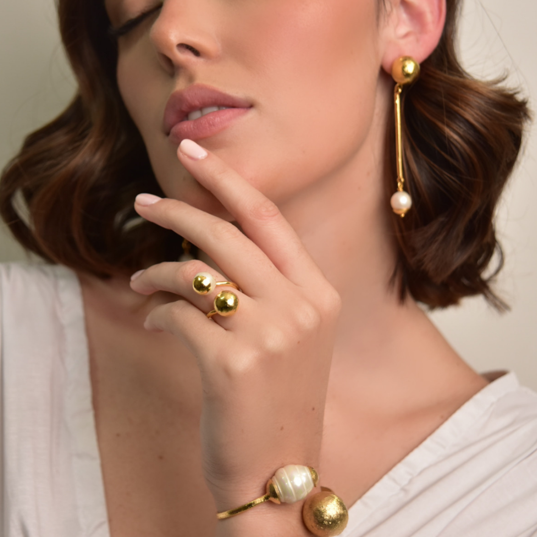 The Bambi ring is handmade by Colombian artisans in bronze with 24-karat gold plating and cultured pearl